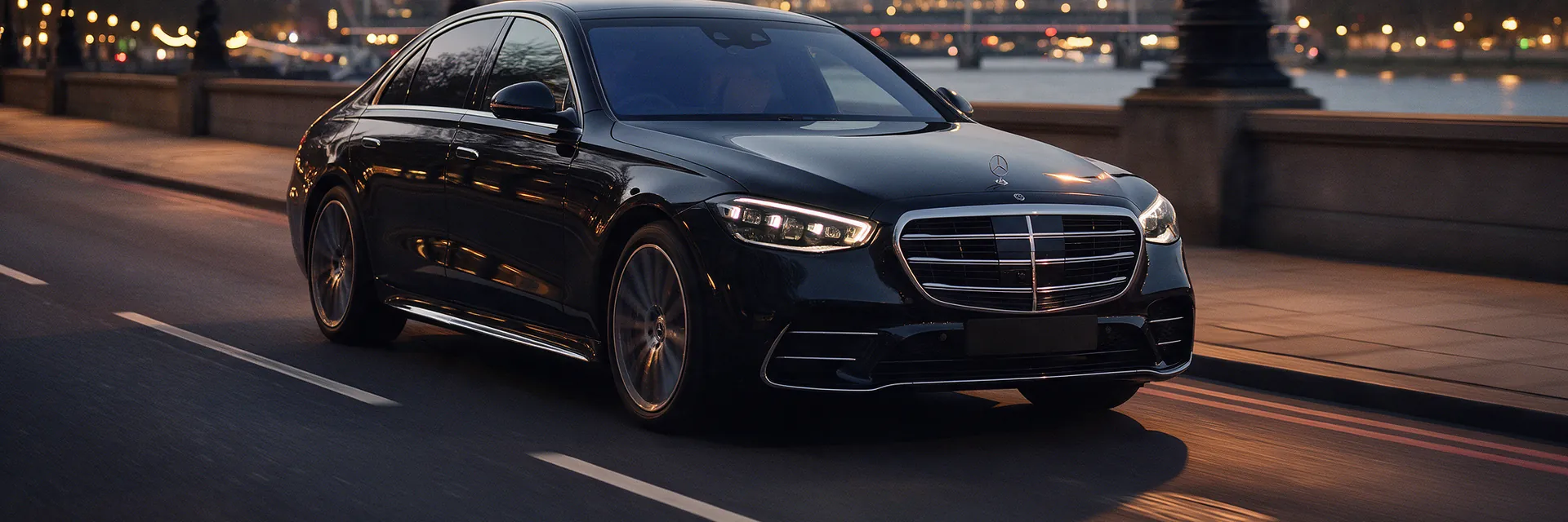 Black Mercedes S Class on the Victoria Embankment at dusk